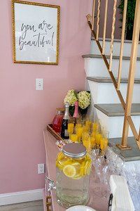 Pink wall with a mimosa bar, a