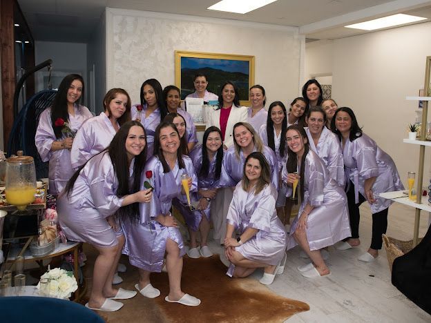 A group of women in purple robes are posing for a picture.