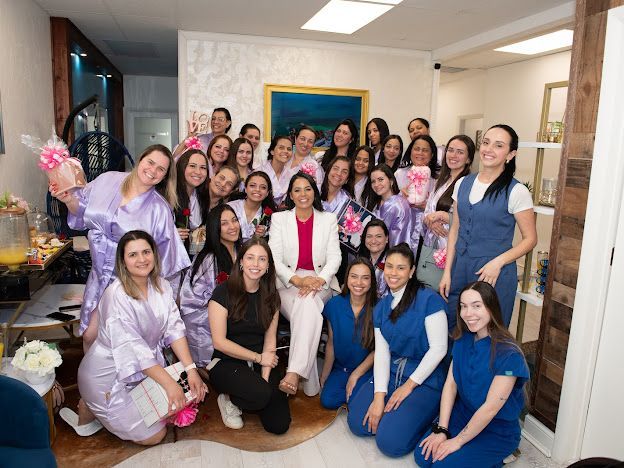 A group of women are posing for a picture in a room.