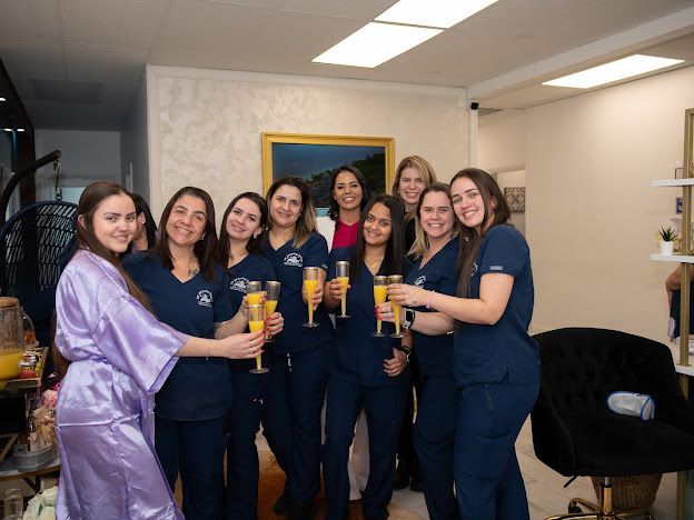 A group of women are standing in a room holding champagne glasses.
