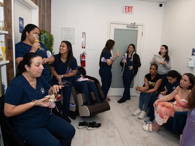 A group of women are sitting in a room with an exit sign.