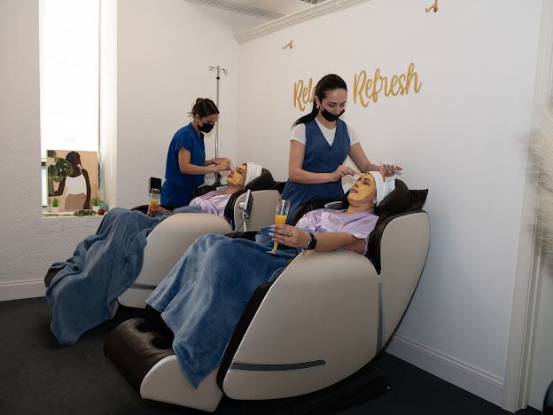 A woman is getting a facial treatment in a massage chair.