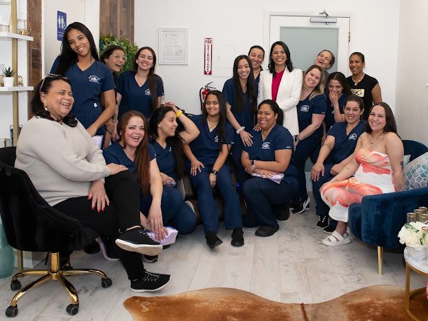 A group of women are posing for a picture in a room.