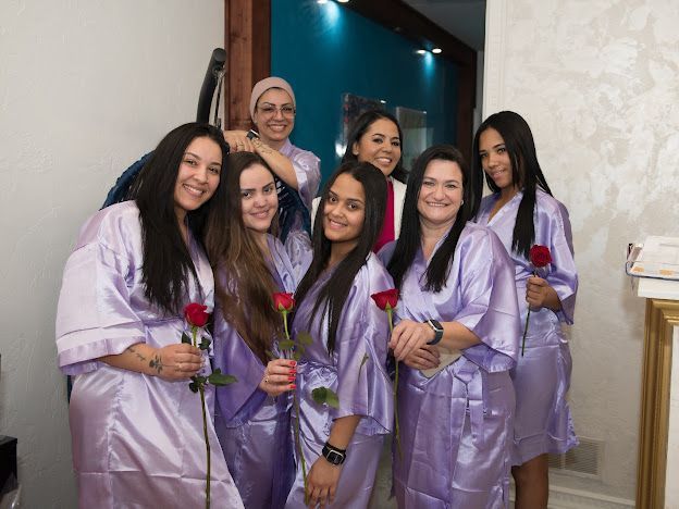 A group of women in purple robes are posing for a picture.