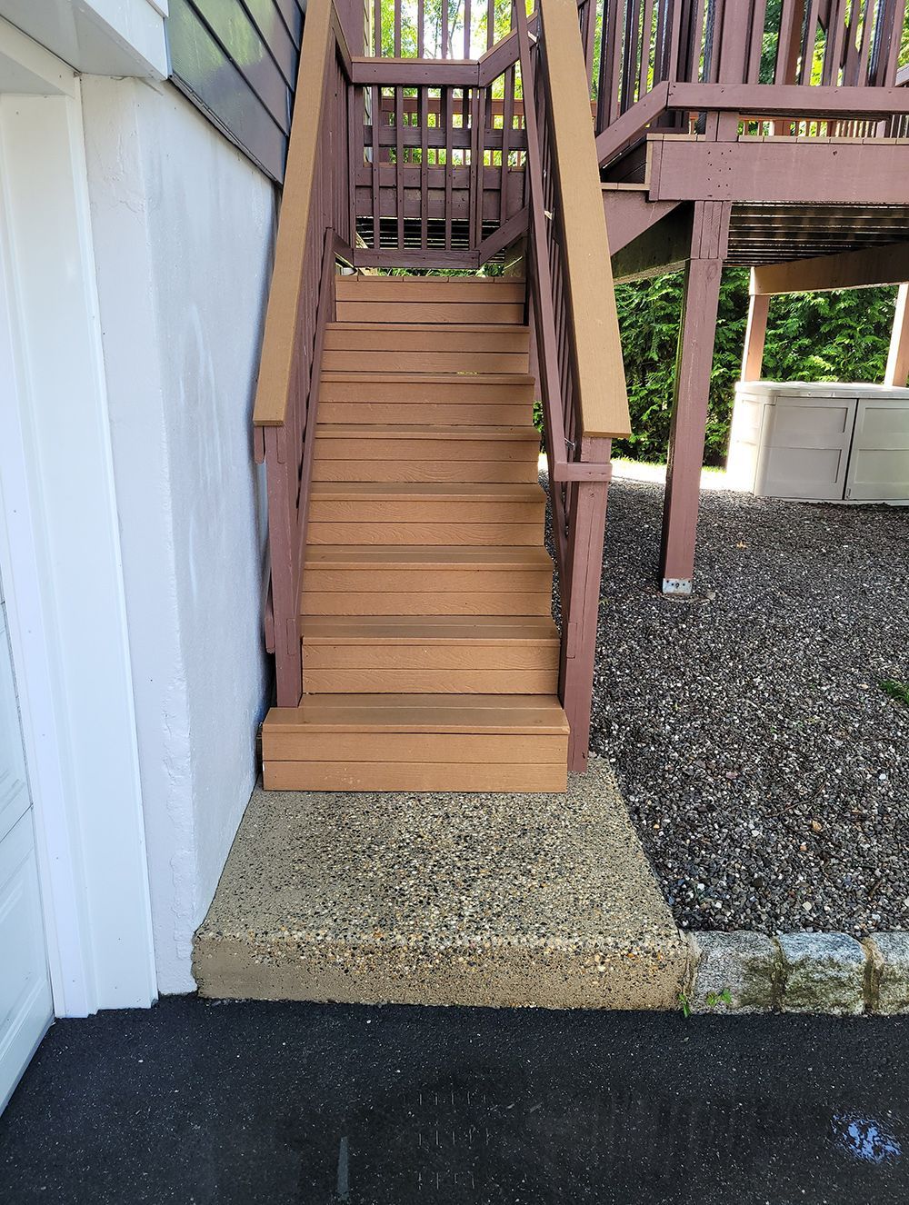 A set of wooden stairs leading up to a deck