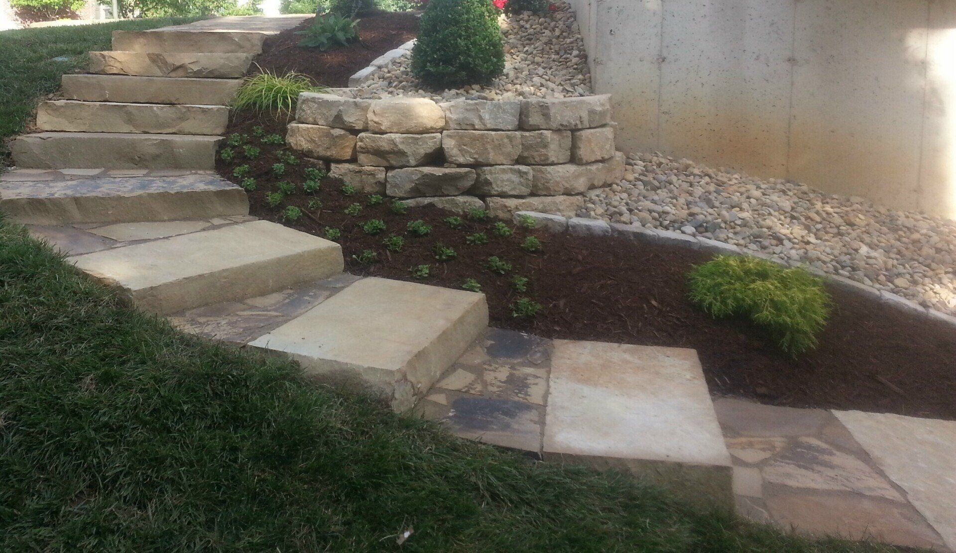 Natural stone steps with landscaping & ledge stone wall