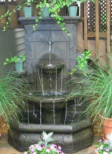 Natural stone wall water feature with gravel accents