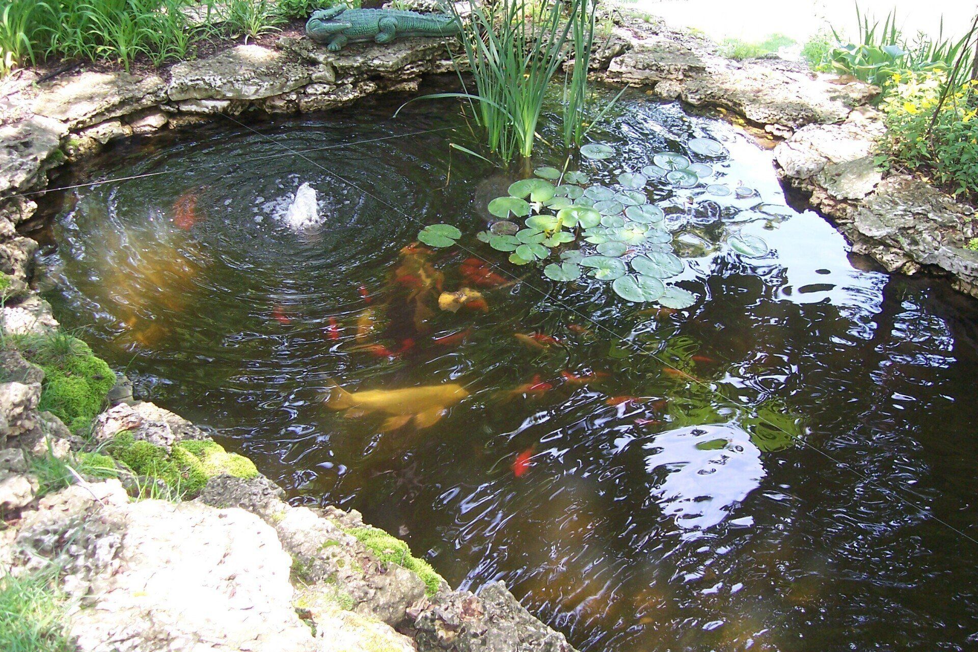 Natural stone wall water feature with gravel accents