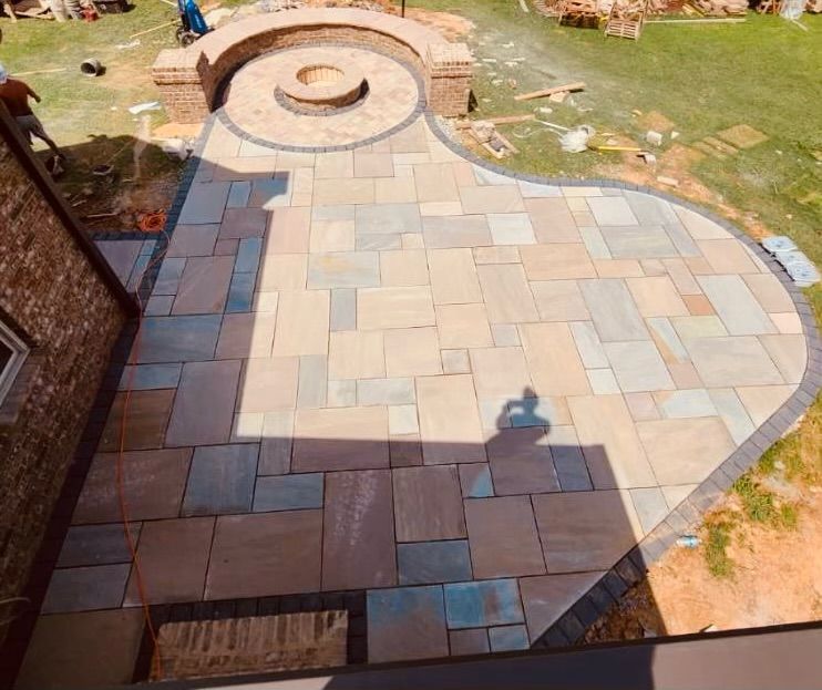 Finished stone patio with fire pit; exterior of house, yard.