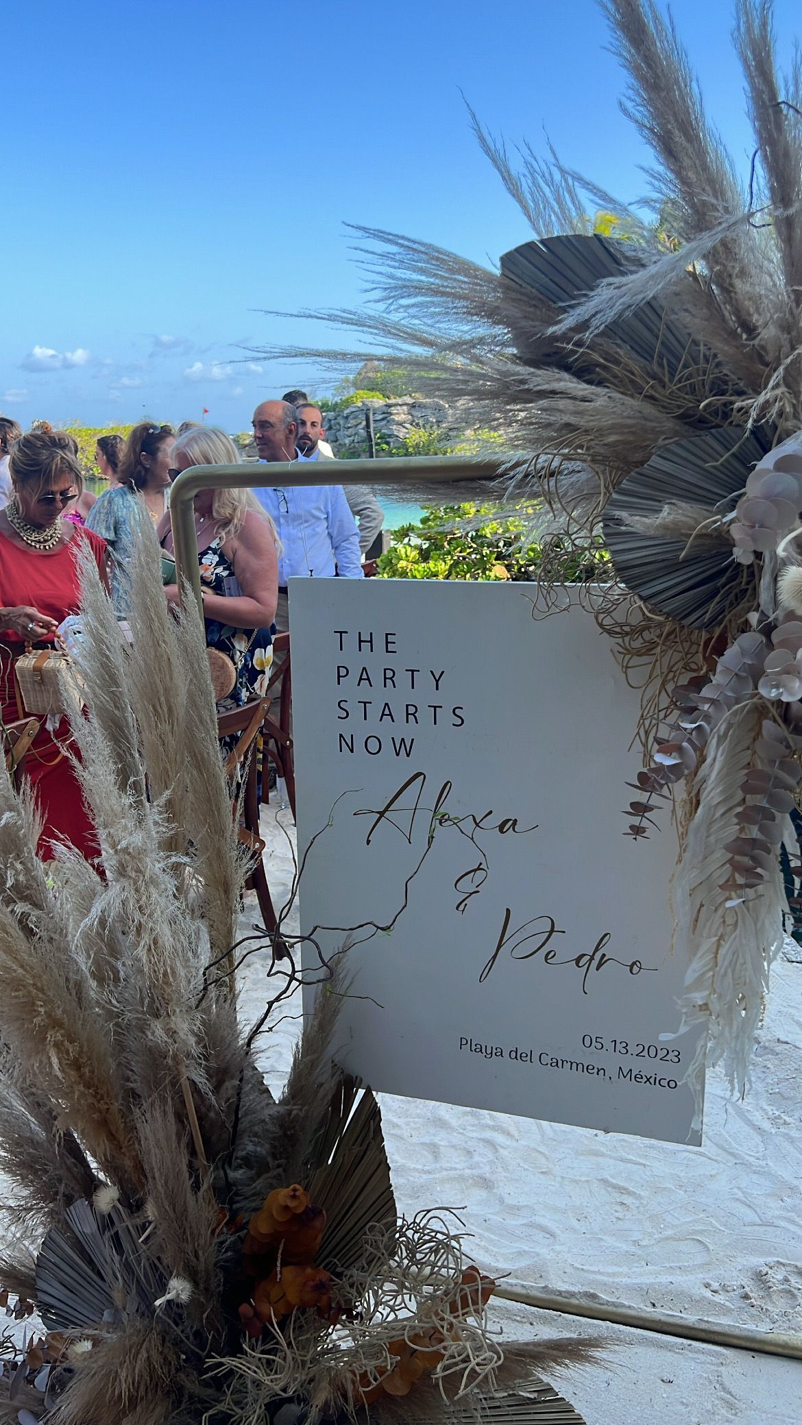 Sign with handwritten text at a beach wedding