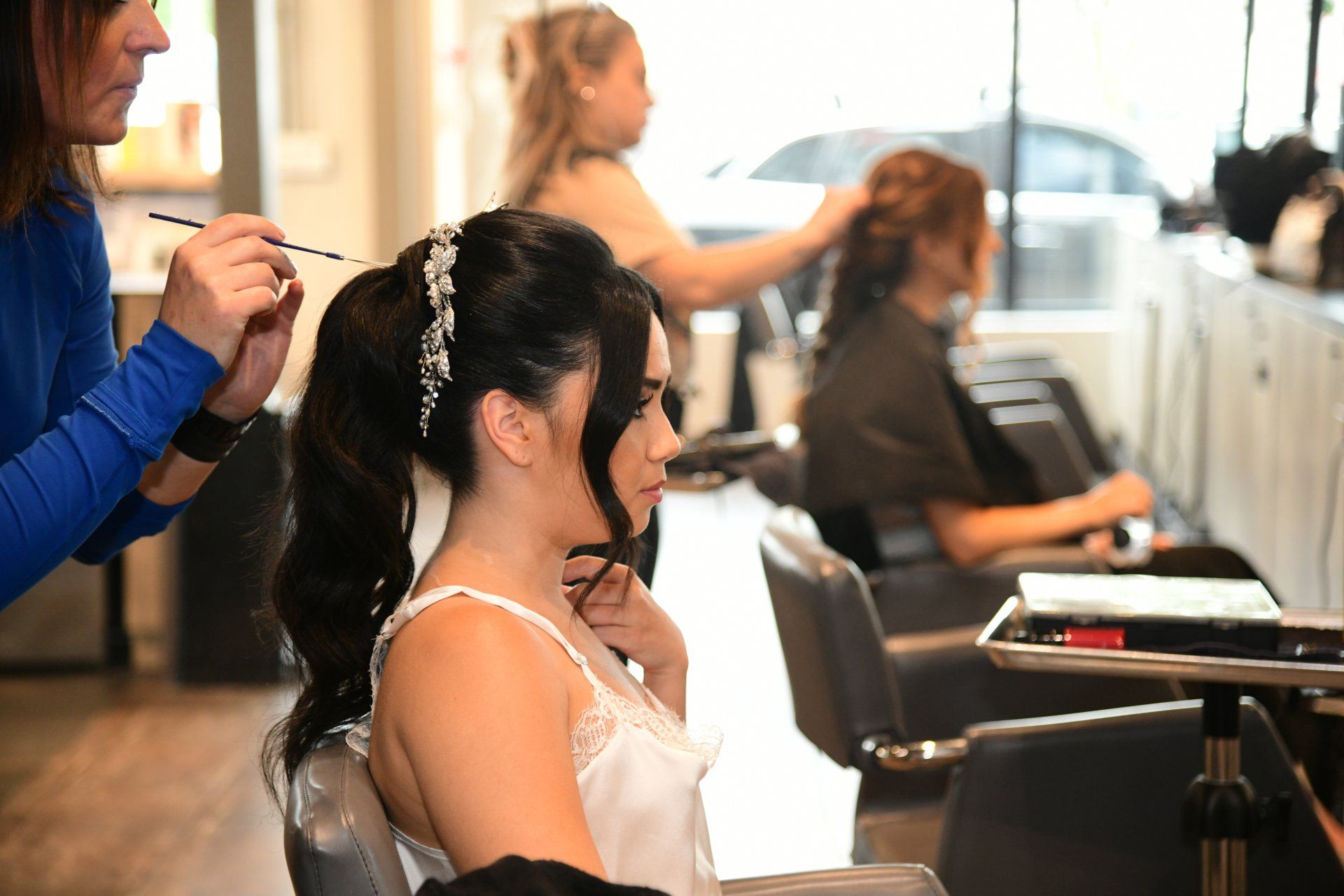 A woman getting her hair styled at a salon