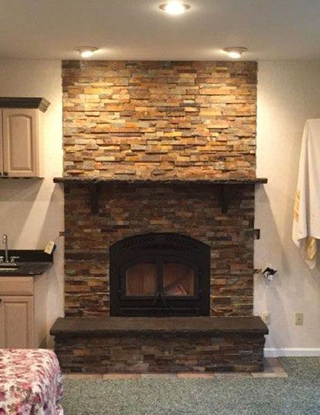 Finished fireplace with Ledgestone. Masonry work performed by Smith's Chimney Service.