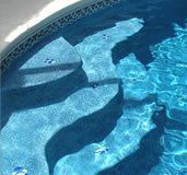 A close up of a swimming pool with stairs in it.