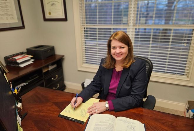 A wooden judge 's gavel is sitting on a wooden table.