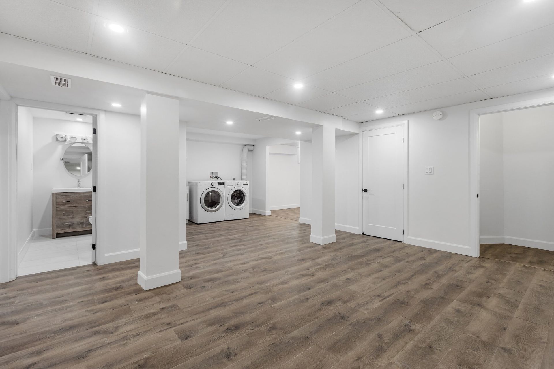There is a laundry room with a washer and dryer in it.