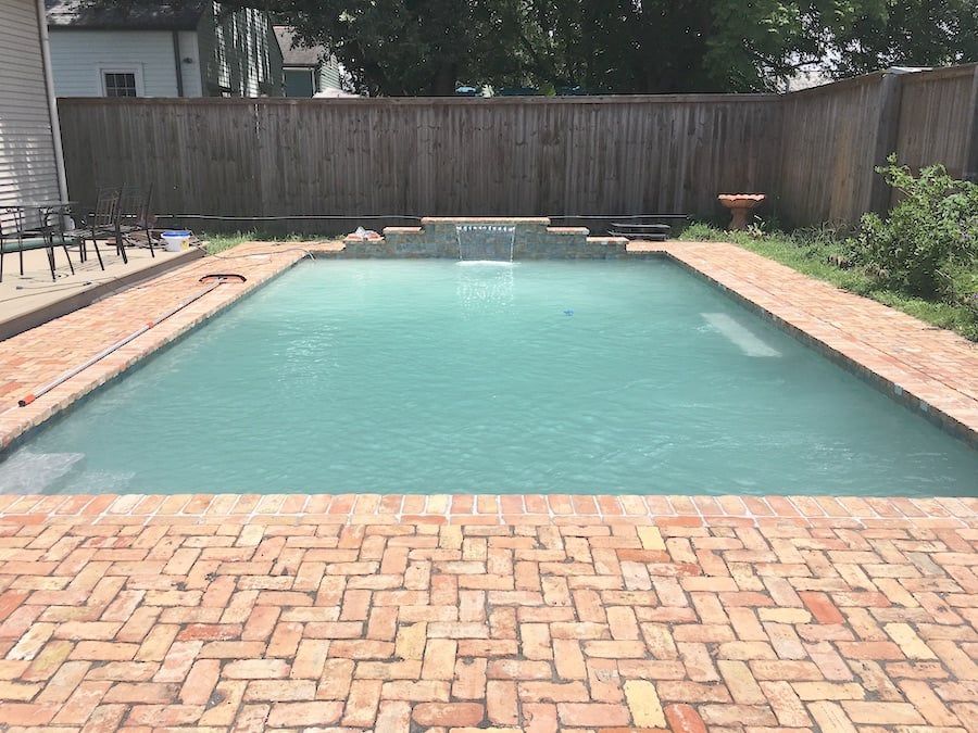 Rectangular in-ground pool with herringbone pavers in Gretna, LA