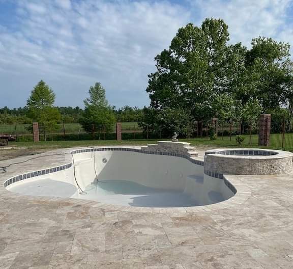 Gunite pool with tanning ledge and spa under construction in Kenner, LA