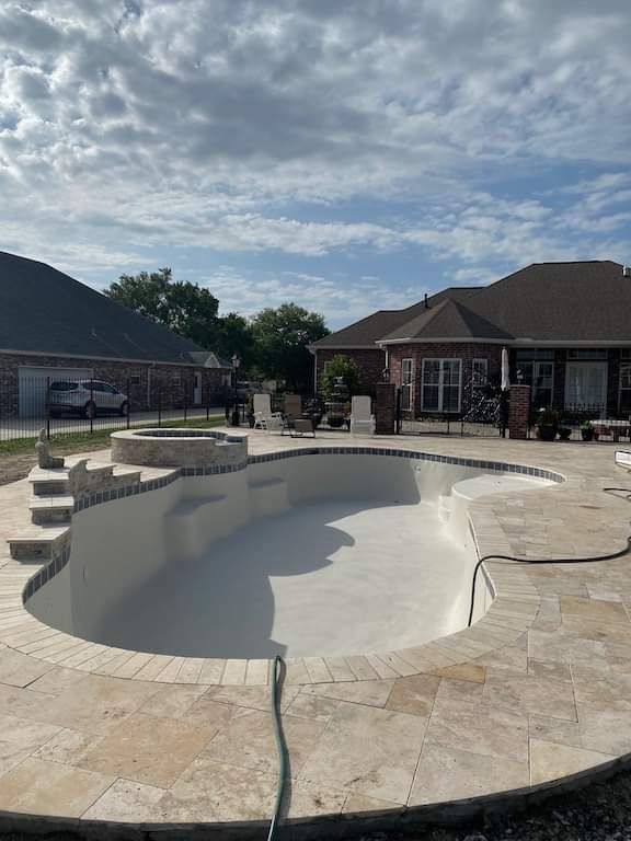 Gunite pool shell shaped and cured in residential backyard in Slidell, LA