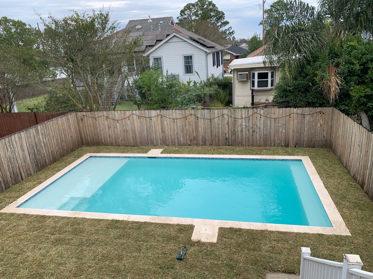 Large residential in-ground swimming pool in backyard in Lacombe, LA