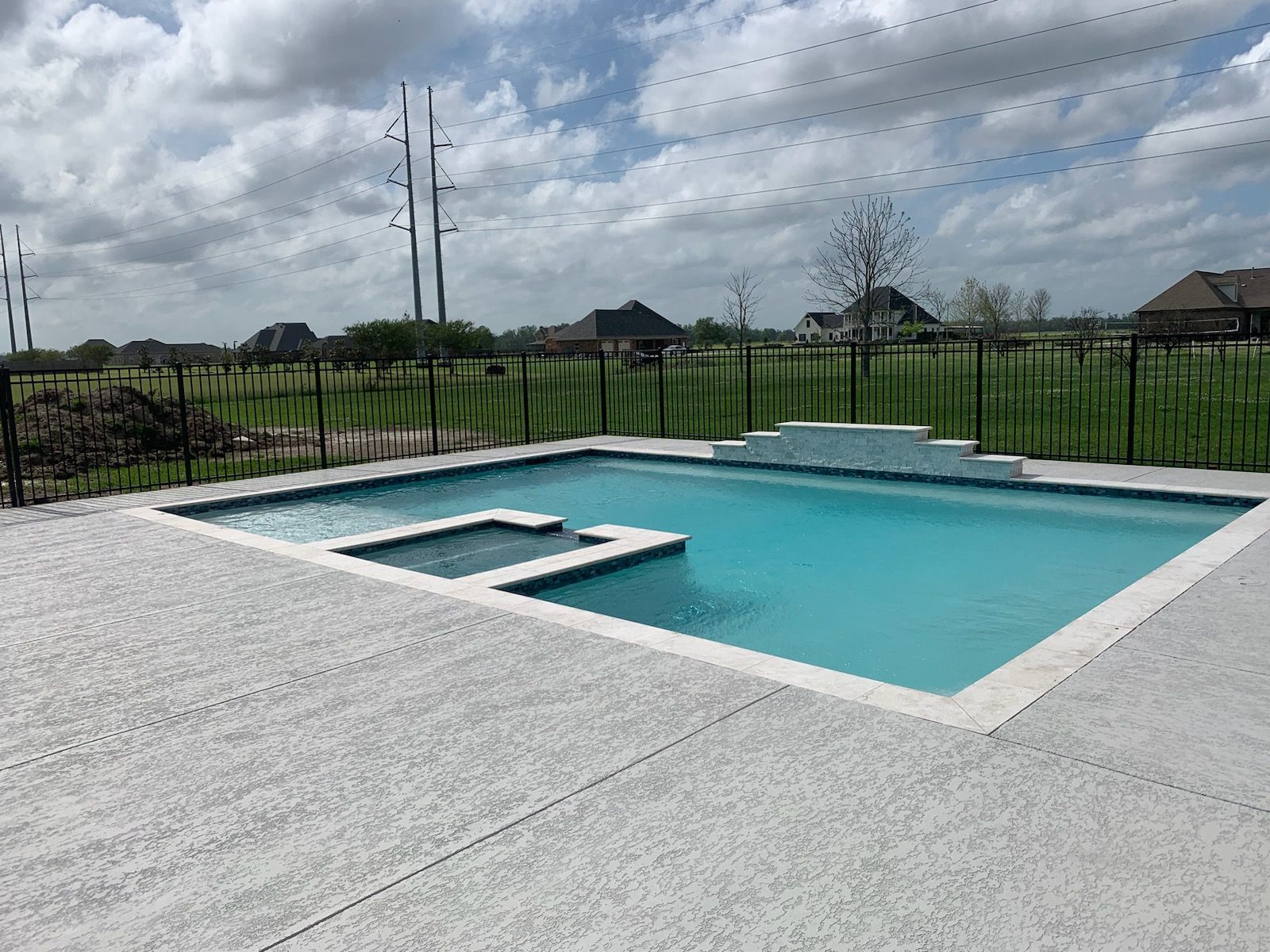 Custom in-ground pool with attached spa in backyard in Gonzales, LA