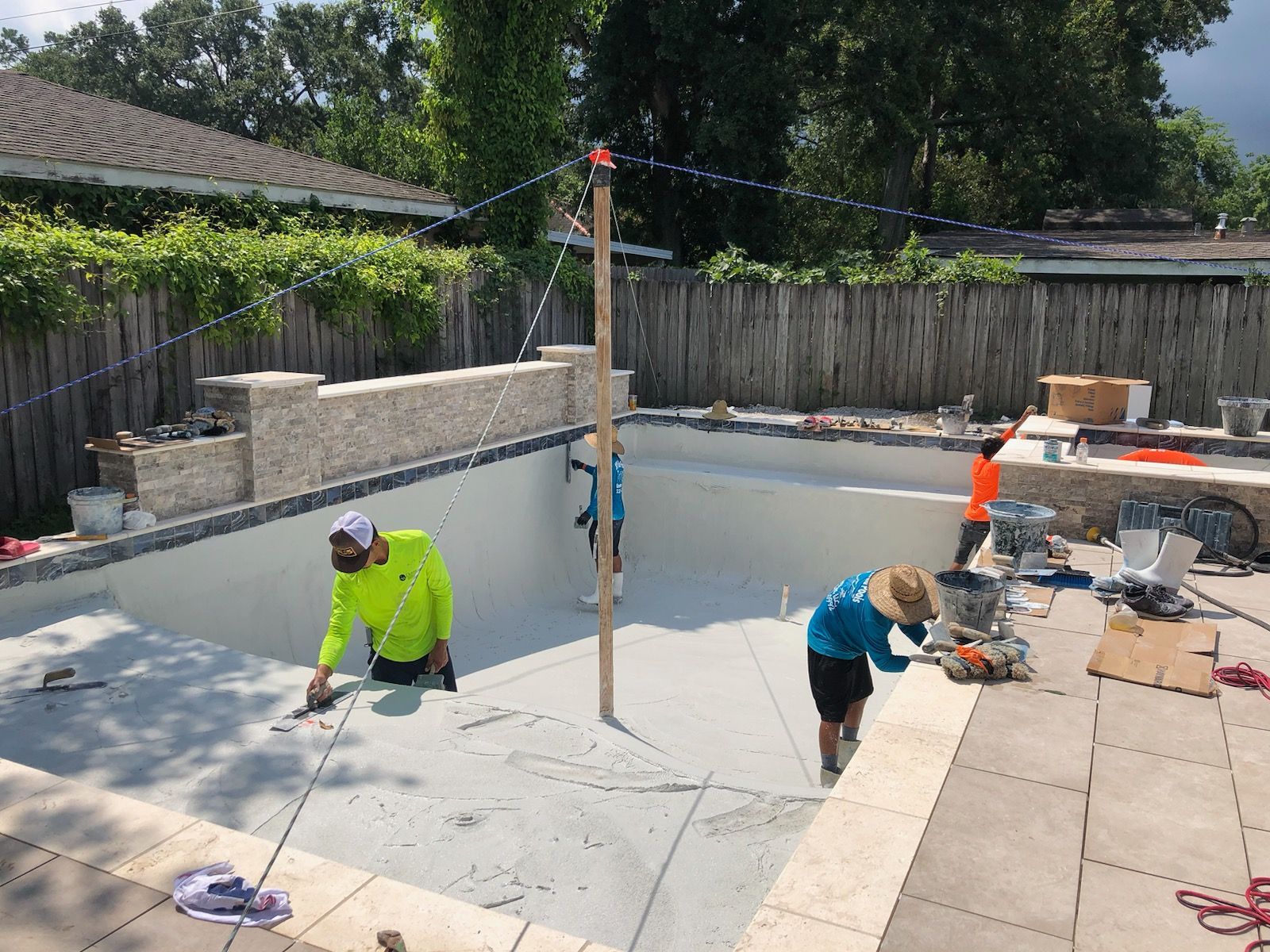 Workers applying gunite to in-ground pool base in Baton Rouge, LA