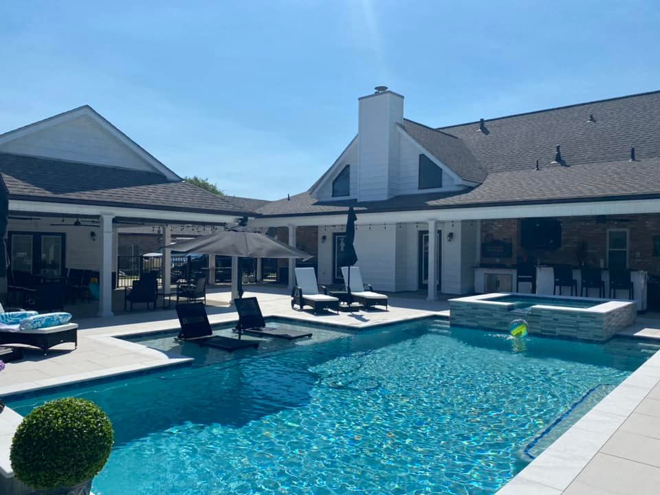Modern in-ground pool with shaded lounge area in Prairieville, LA