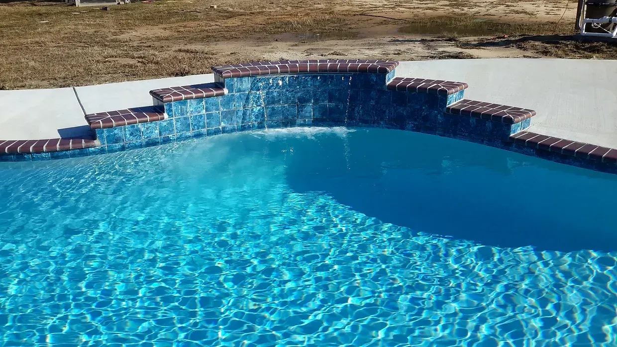 Custom pool with brick steps and crystal-clear water in LaPlace, LA