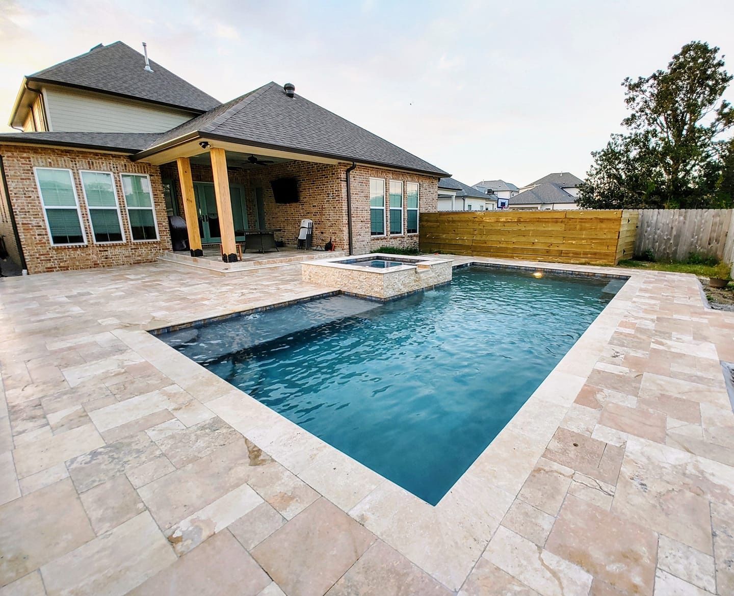 A large swimming pool is in the backyard of a house, Covington LA