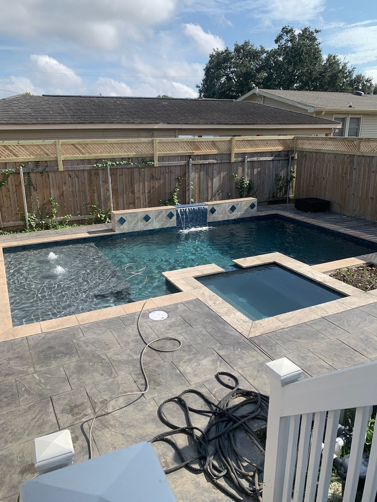 A large custom in-ground pool with spa and waterfall feature in Houma, LA