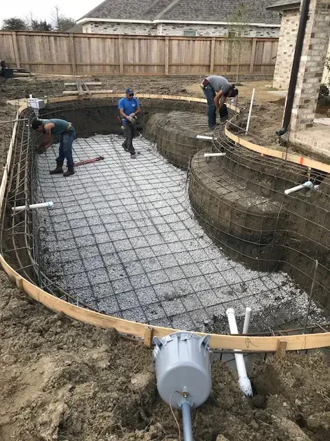 Steel rebar framework set for gunite pool installation in Mandeville, LA
