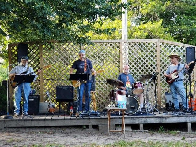 A group of men playing guitars and drums on a stage