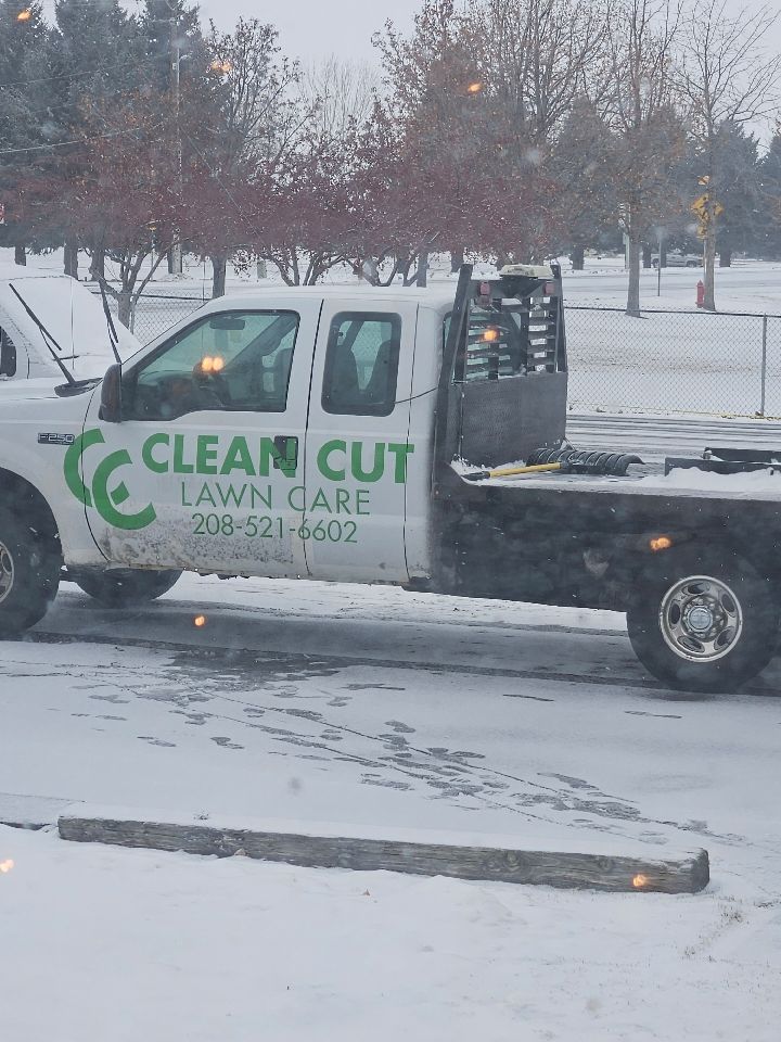 Snow-covered lawn care truck with “Clean Cut” logo parked in a winter lot