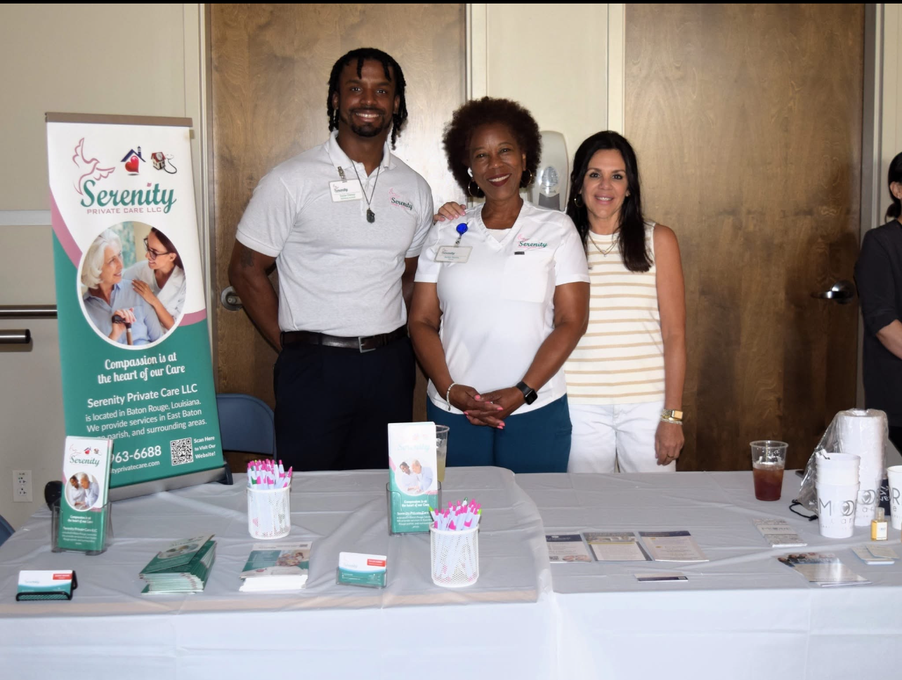 A group of people standing around a table with a sign that says serenity
