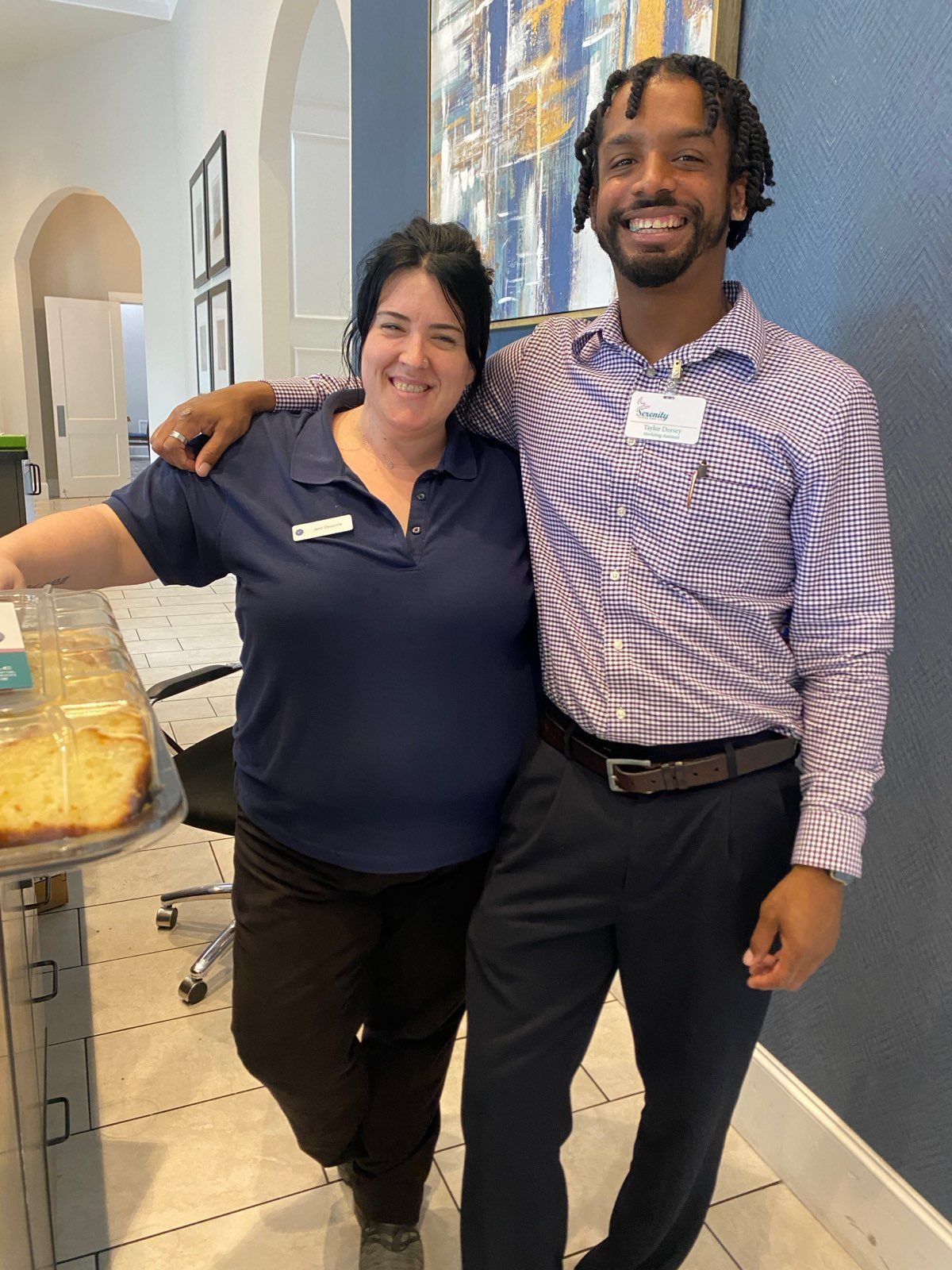 A man and a woman are posing for a picture in a room.
