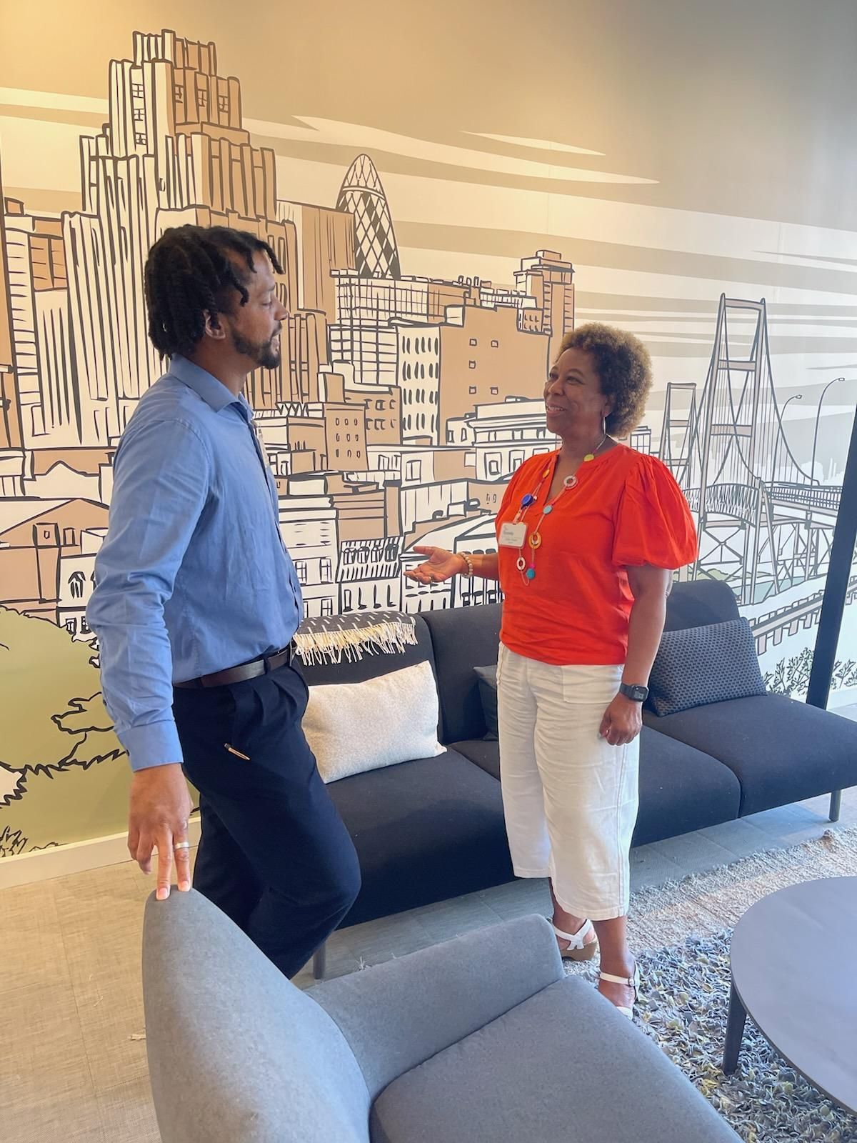 A man and a woman are standing next to each other in a living room.