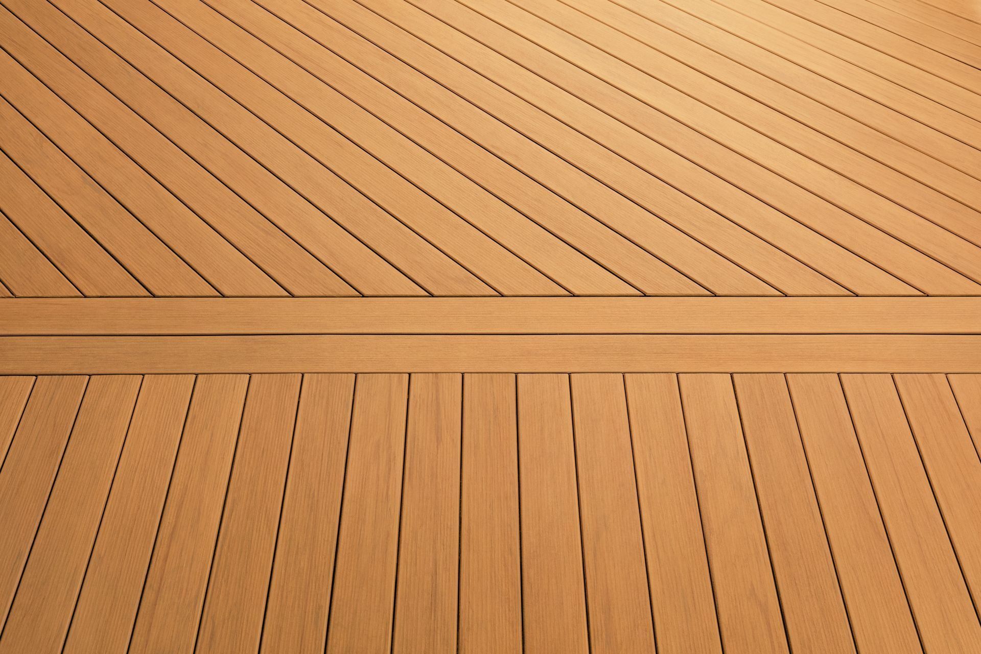 Close-up of a light tan wooden deck with diagonal planks and a horizontal seam