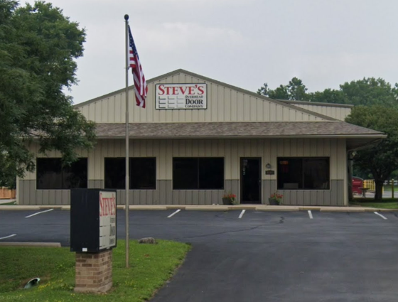 Steve’s Home Services building with a U.S. flag, parking lot, and sign out front