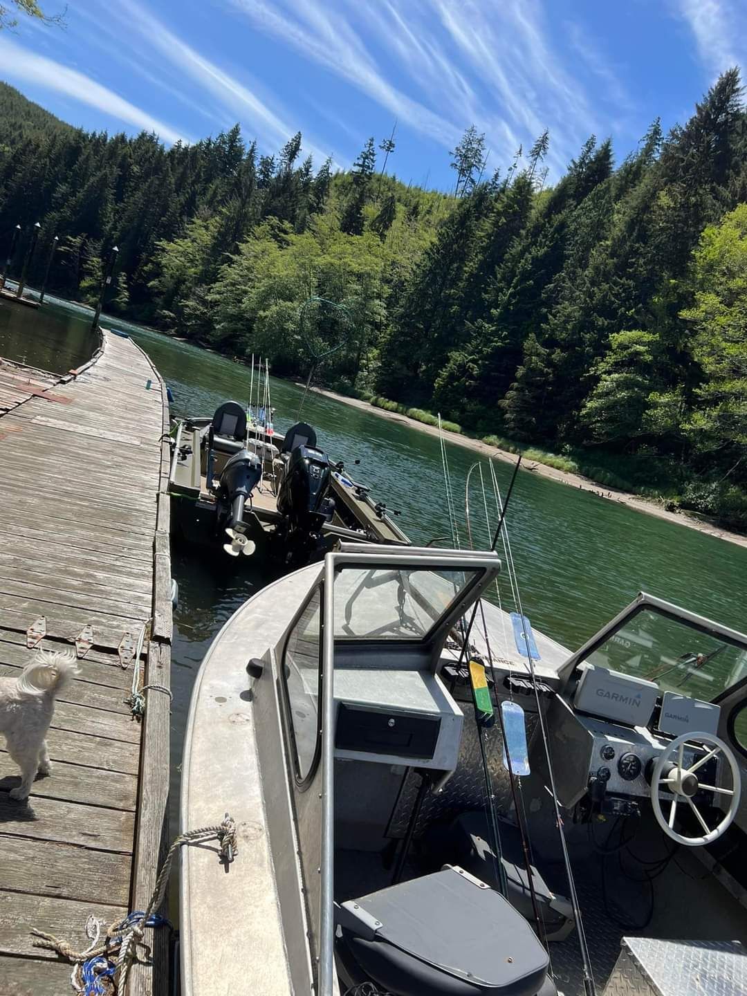 A boat is docked at a dock next to a lake.