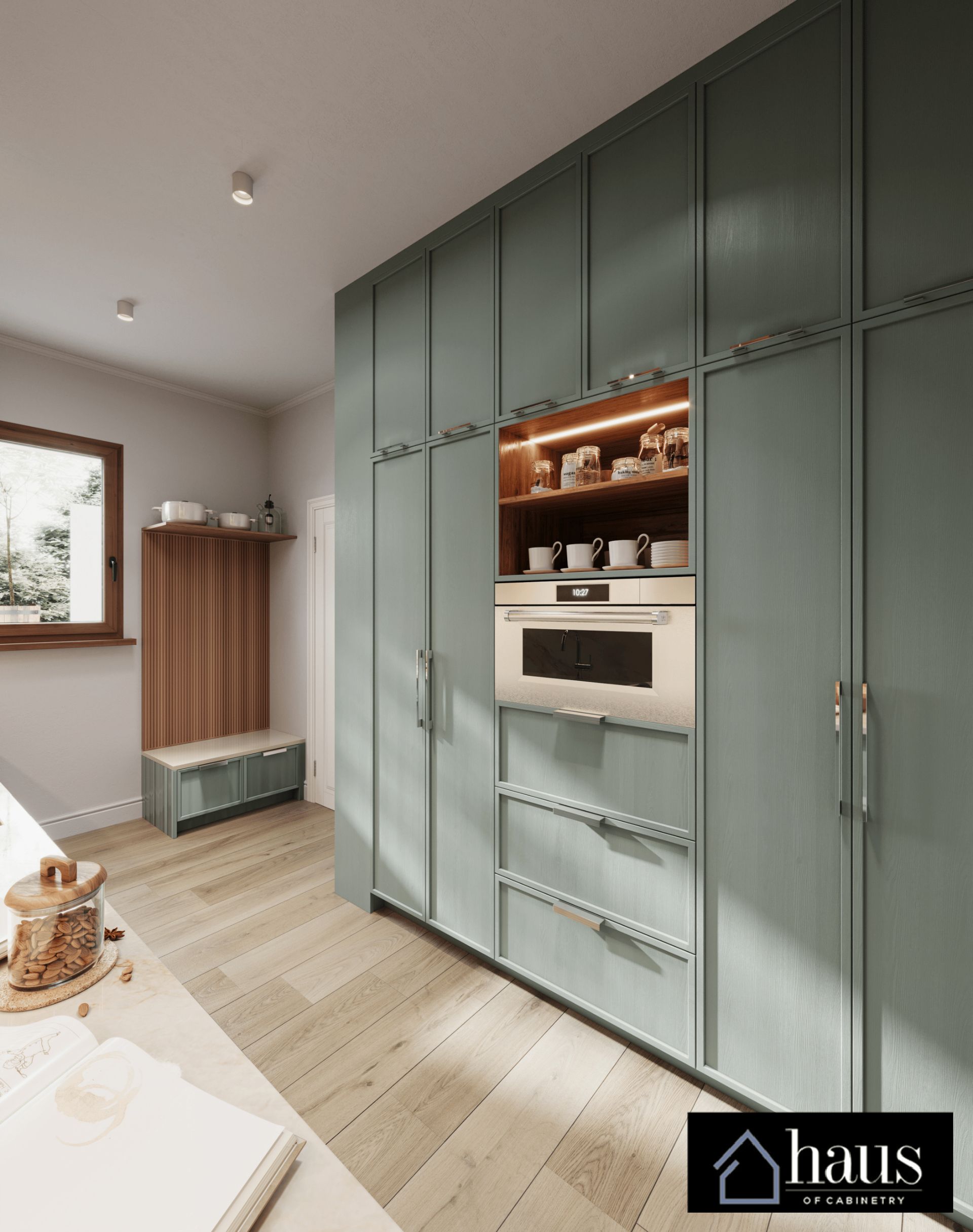 A modern sage-green floor-to-ceiling kitchen cabinet unit with a built-in oven, coffee station, and wood-paneled mudroom.