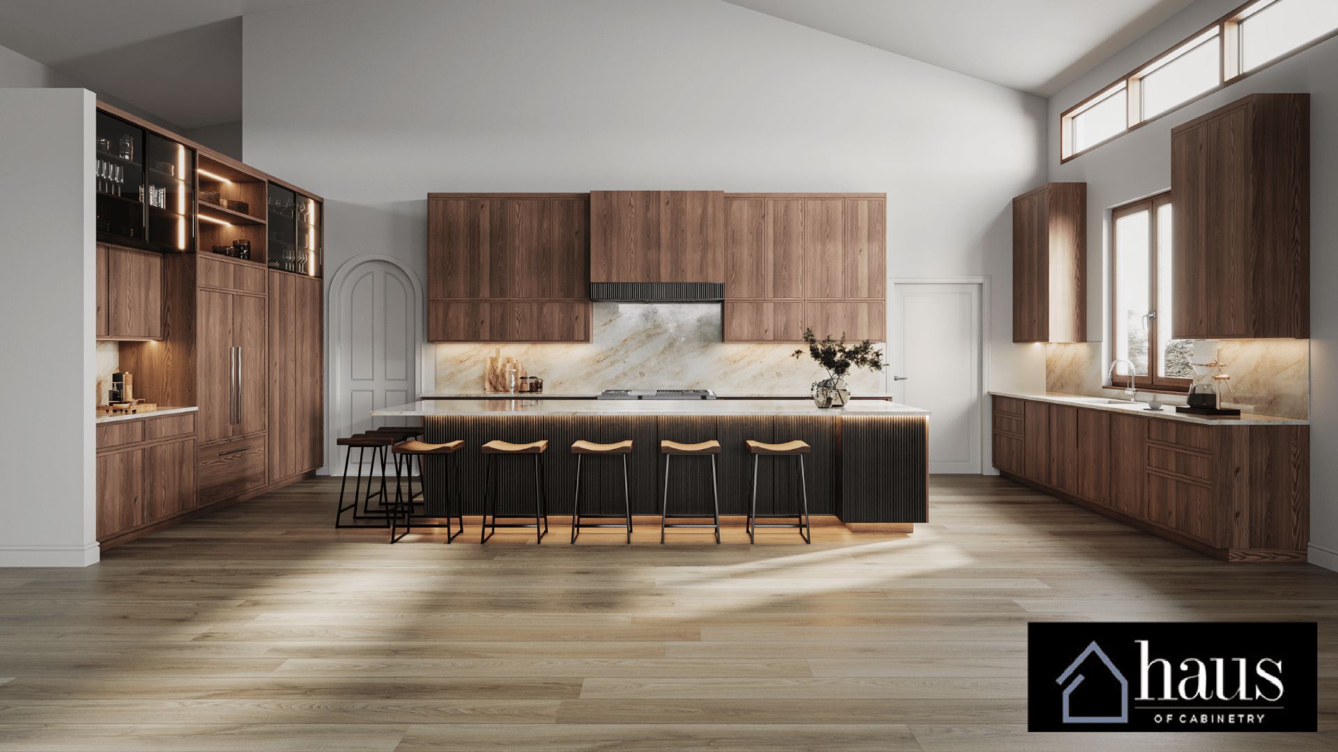 A modern kitchen with dark wood cabinets, a large island with five stools, and light wood flooring under a vaulted ceiling.