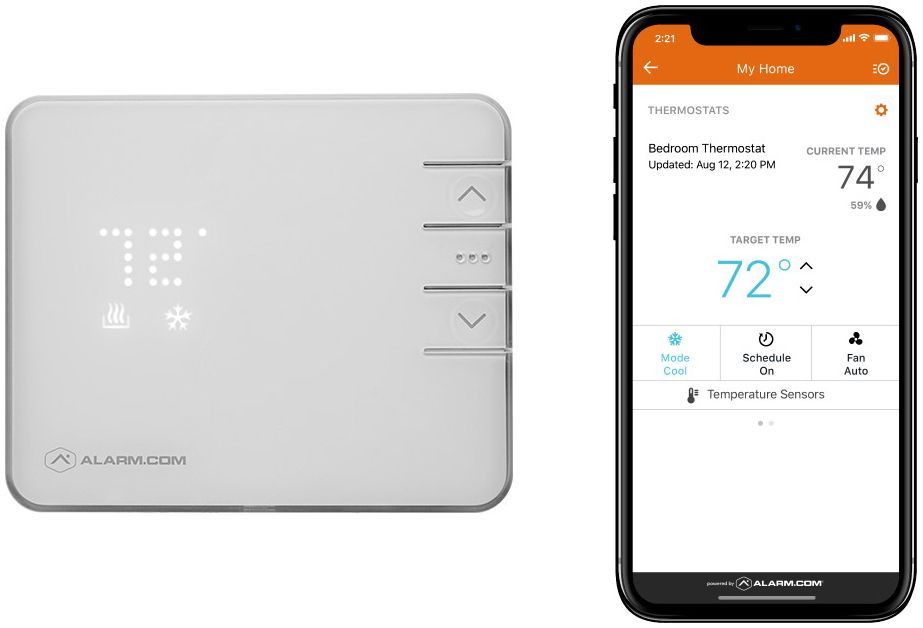 A smart thermostat is sitting next to a smart phone.
