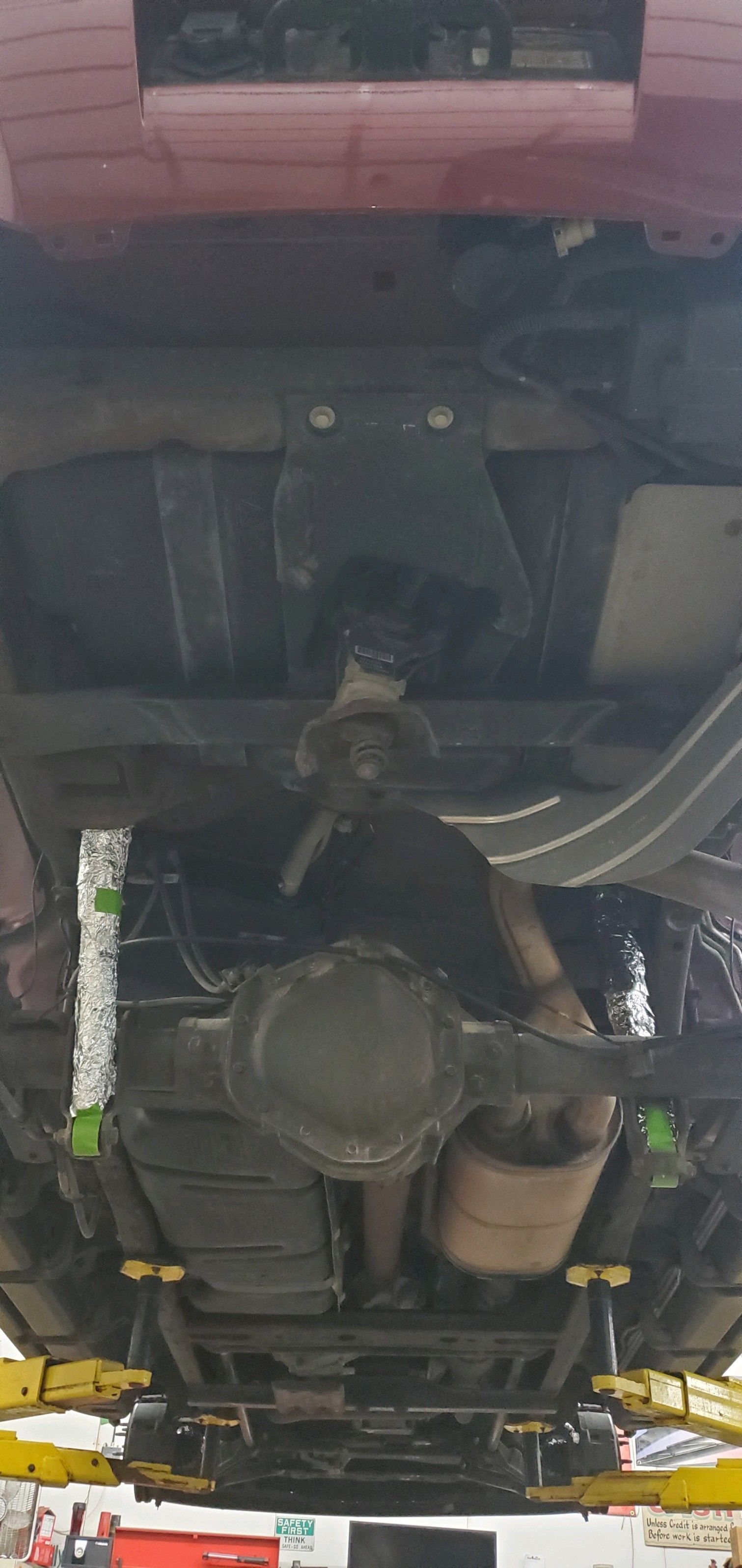 a close-up of the underside of a car on a lift