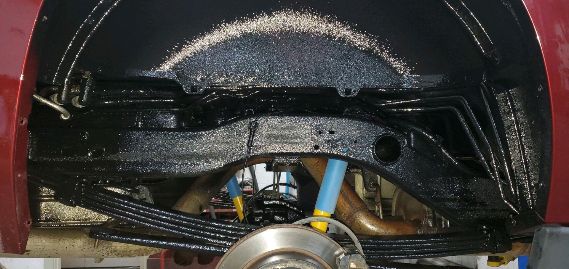 a close up of the underside of a red car