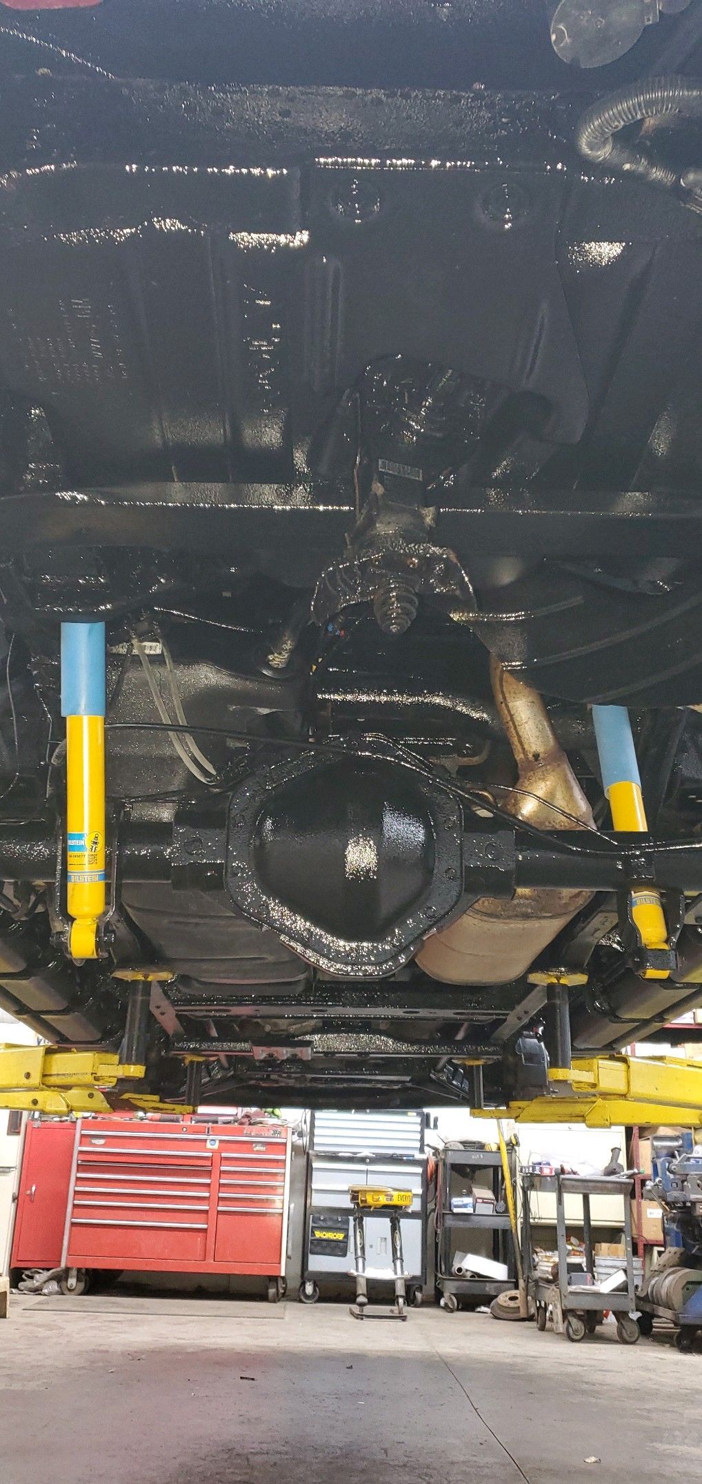 a car is sitting on a lift in a garage