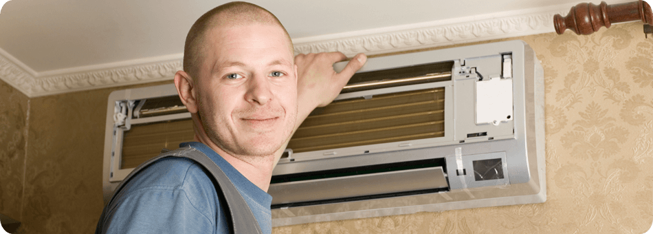 Man smiling with a air conditioning unit behind him