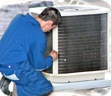 Repairman fixing a big air conditioning unit
