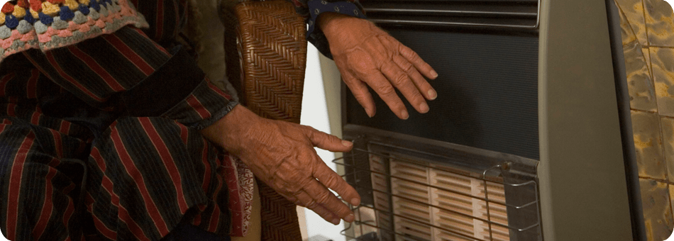 Pair of hands being warmed up by a electric heater