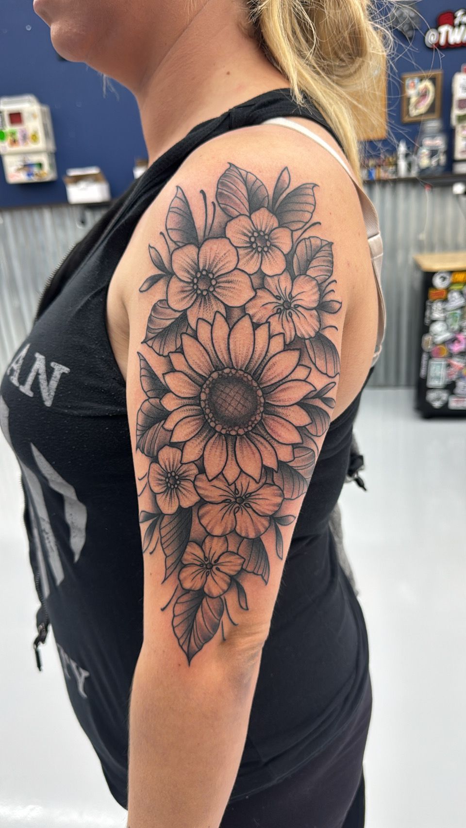 A woman has a tattoo of flowers on her arm