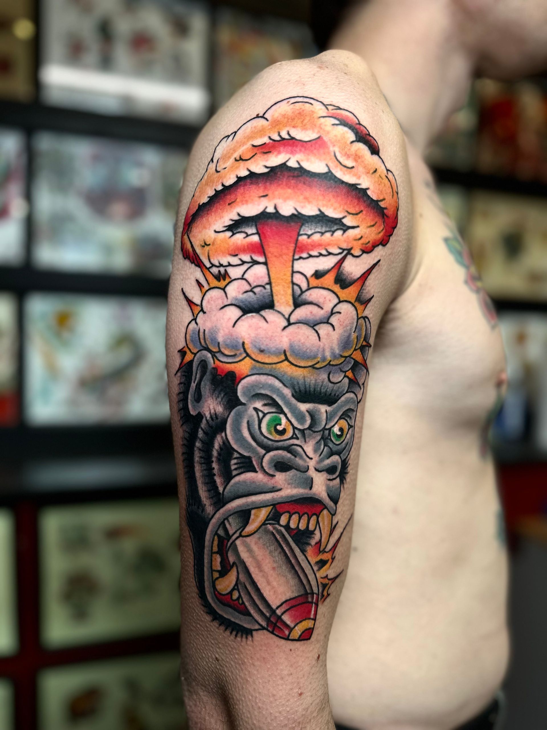 A man has a tattoo of a gorilla and a mushroom on his arm