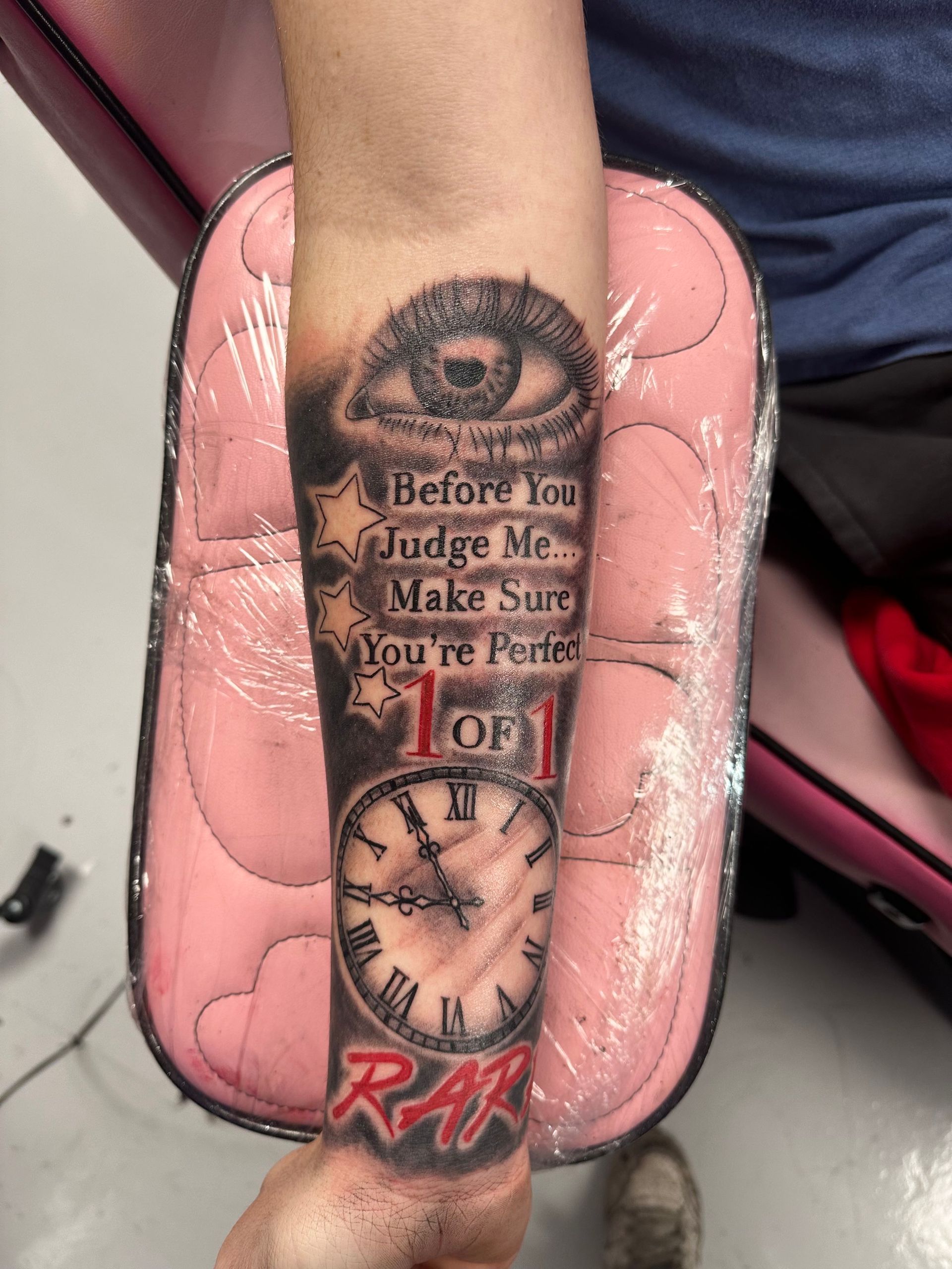 A person has a tattoo on their arm